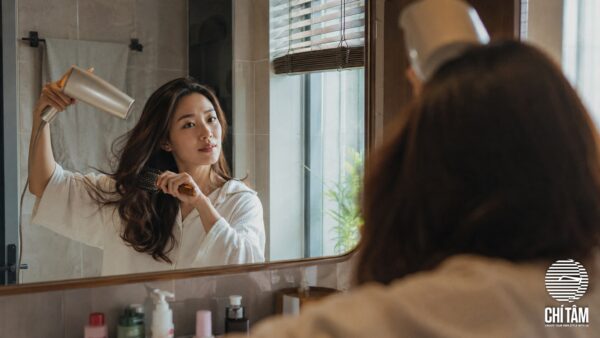 Phụ nữ sấy tóc đúng cách trước gương tại nhà - Chí Tâm Hair Salon