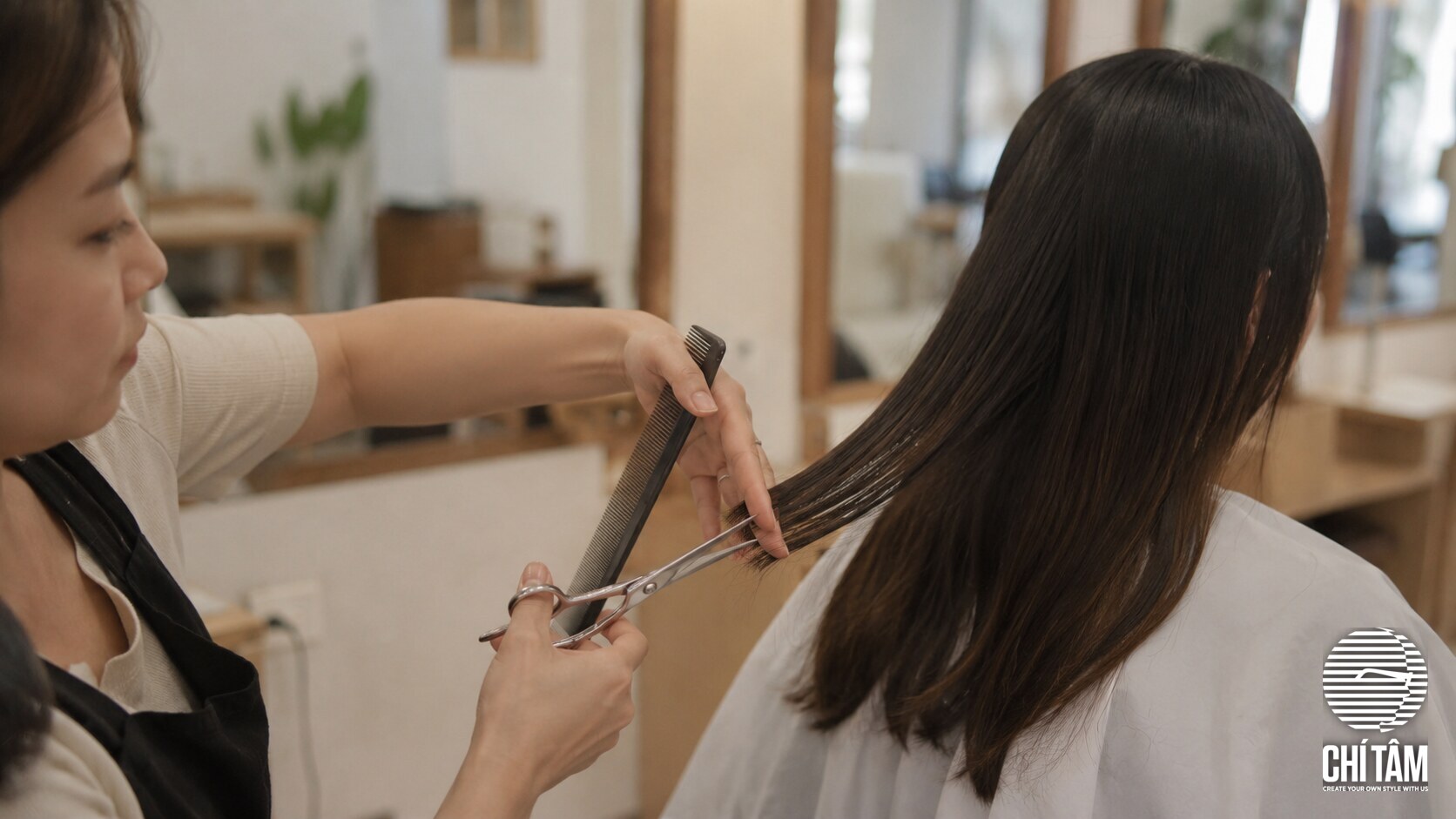 Stylist Chí Tâm tỉa gọn phần ngọn tóc chẻ cho khách